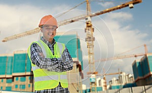 Foreman construction worker standing crossing hands smiling