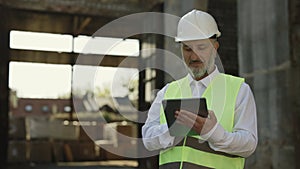 Foreman contacting with contractor by tablet outdoor