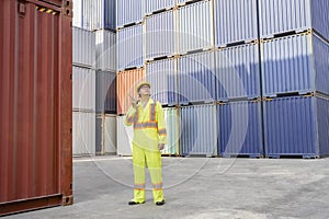 foreman control loading containers box from cargo freight ship working at dock site