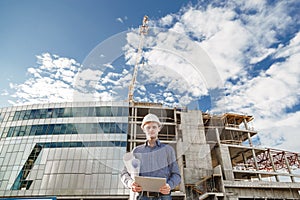 Foreman with digital tablet supervising the project at the construction.