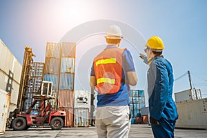 Foreman and dock worker staff pointing the finger and working at Container cargo harbor. Business Logistics import export shipping