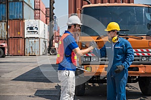 Foreman and dock worker staff shaking hand for sucess working at Container cargo harbor. Business Logistics import export shipping