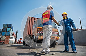 Foreman and dock worker staff shaking hand for sucess working at Container cargo harbor. Business Logistics import export shipping