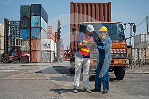 Foreman and dock worker staff working checking at Container cargo harbor holding clipboard. Business Logistics import export