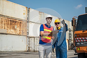 Foreman and dock worker staff working checking at Container cargo harbor holding clipboard. Business Logistics import export