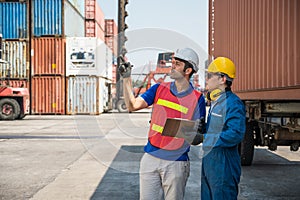 Foreman and dock worker staff working checking at Container cargo harbor holding clipboard. Business Logistics import export