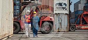 Foreman and dock worker staff working checking at Container cargo harbor holding clipboard. Business Logistics import export