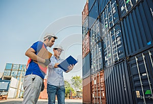 Foreman and dock worker staff working checking at Container cargo harbor holding clipboard. Business Logistics import export