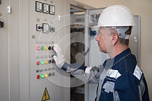 Foreman electrician next to the dashboard. Energy and electrical safety