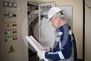 Foreman electrician next to the dashboard. Energy and electrical safety