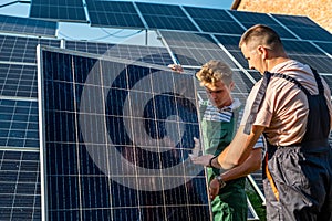 Foreman and engineer installing solar photovoltaic panels