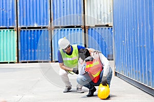 Foreman is fainting. Young man is sick due to hard work. Foreman working in the port with shipping containers