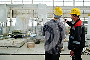 Foreman giving task to worker in plant