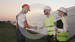 Foreman greeting inspectors with hand shaking at solar farm.