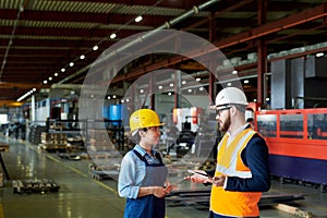 Foreman Instructing Worker at Plant