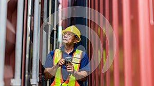 Foreman man working checking at Container cargo harbor to loading containers. Professional foreman work at Container cargo site ch