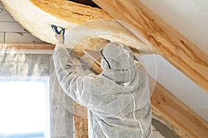 Foreman in overalls working with rockwool insulation material