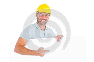 Foreman pointing at blank board on white background