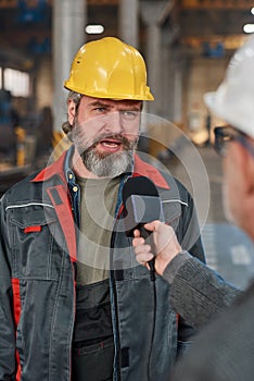 Foreman talking to journalist at plant