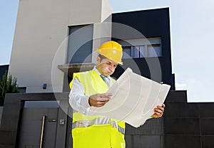 Foreman worker in stress supervising building blueprints outdoors wearing construction helmet