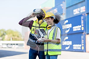 Foreman or worker use remote controller piloting drone at containers port for checking container. Foreman use remote control Drone