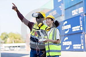 Foreman or worker use remote controller piloting drone at containers port for checking container. Foreman use remote control Drone