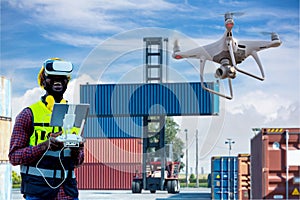 Foreman or worker use remote controller piloting drone at containers port for checking container. Foreman use remote control Drone