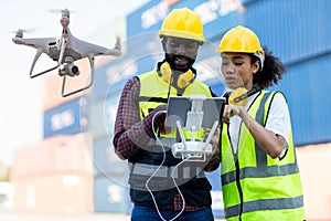 Foreman or worker use remote controller piloting drone at containers port for checking container. Foreman use remote control Drone