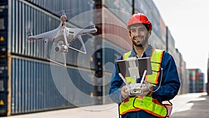 Foreman or worker use remote controller piloting drone at containers port for checking container. Foreman use remote control Drone