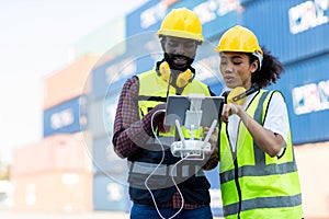 Foreman or worker use remote controller piloting drone at containers port for checking container. Foreman use remote control Drone