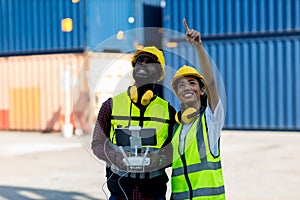 Foreman or worker use remote controller piloting drone at containers port for checking container. Foreman use remote control Drone