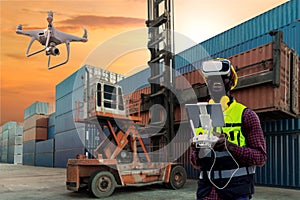 Foreman or worker use remote controller piloting drone at containers port for checking container. Foreman use remote control Drone