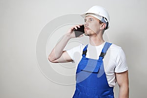 Foreman worker using smartphone on white background