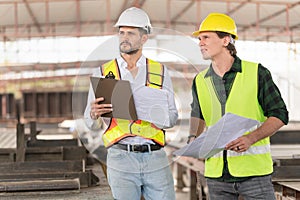 Foreman and workers team meeting for planning project at precast concrete factory site, Site manager and builder on construction