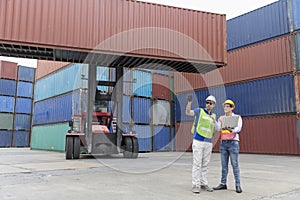 Foreman is working in a port with a container. businessman and Foreman control loading Containers from Cargo