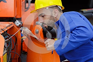 Foremaster inspecting a machinery photo