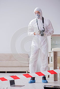 The forensic expert at crime scene doing investigation