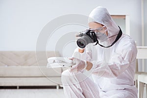 The forensic expert at crime scene doing investigation