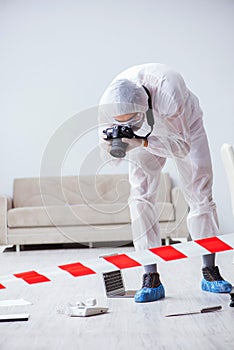 The forensic expert at crime scene doing investigation