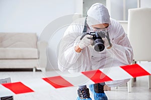 The forensic expert at crime scene doing investigation