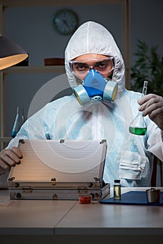 The forensic investigator working in lab looking for evidence
