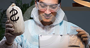 Forensic investigator working in lab looking for evidence