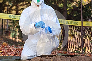 Forensic science specialist at work at a war crime scene investigation