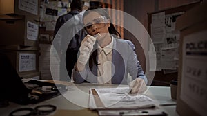 Forensic scientist lady examining the evidence bullet from the crime scene