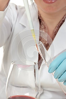 Forensic scientist taking sample from glass