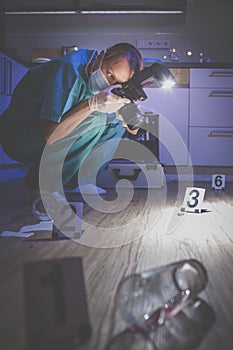 Forensic specialist  taking photos on a crime scene
