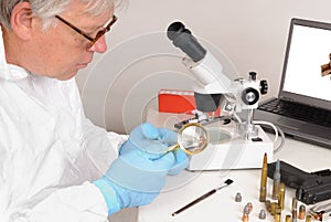 Forensic technician checking bullet