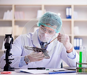 Forensics investigator working in lab on crime evidence photo