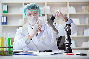 The forensics investigator working in lab on crime evidence