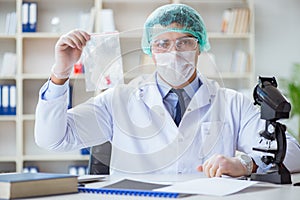 The forensics investigator working in lab on crime evidence